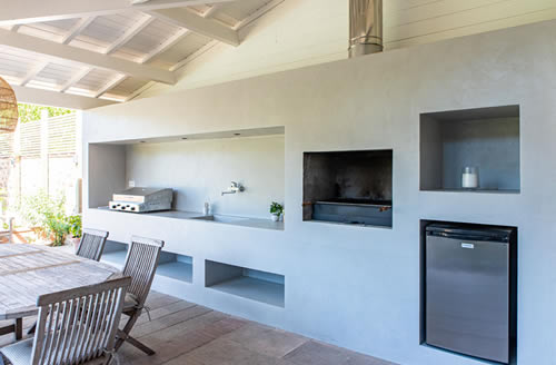 Summer kitchen with reinforced concrete structure and polished concrete finish